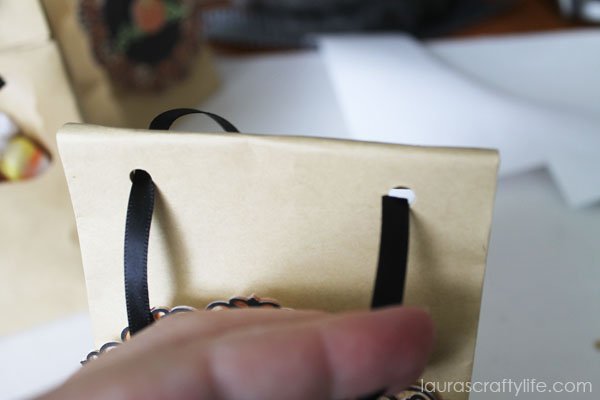 Punch holes and thread ribbon through to secure treat bag