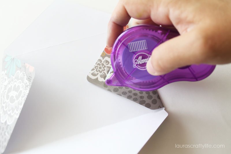 Add adhesive to small flaps to create envelope