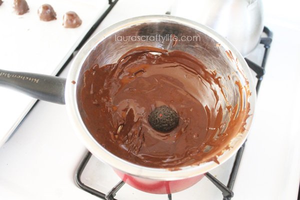 Dip OREO balls into chocolate
