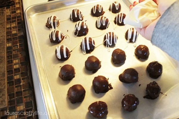 Drizzle OREO cookie balls with melted white chocolate
