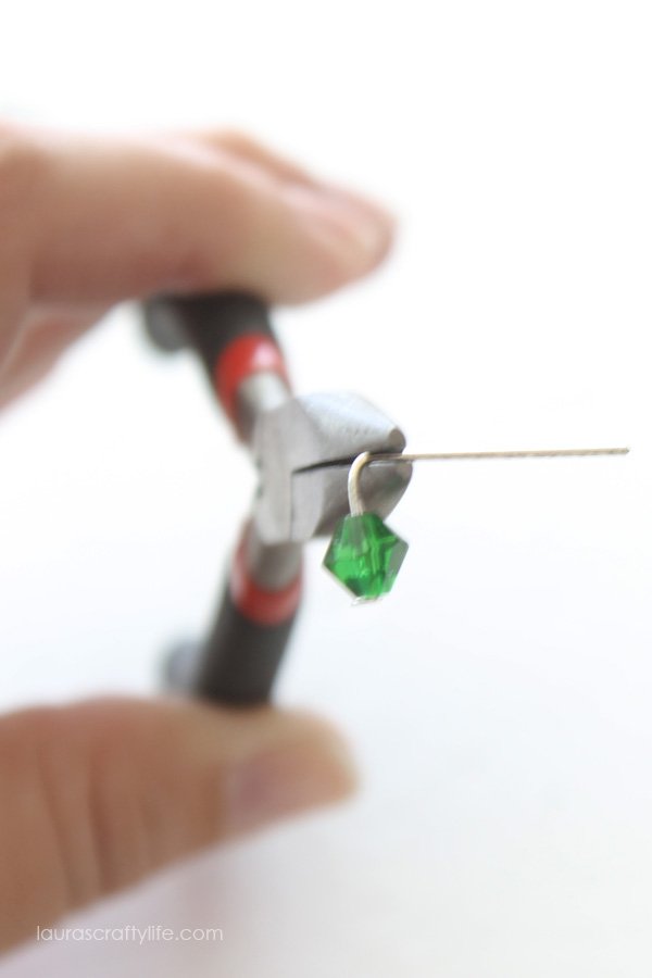 Use needle nose pliers to bend head pin