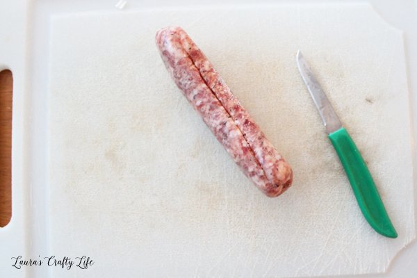Cut slit in sausage to remove casing