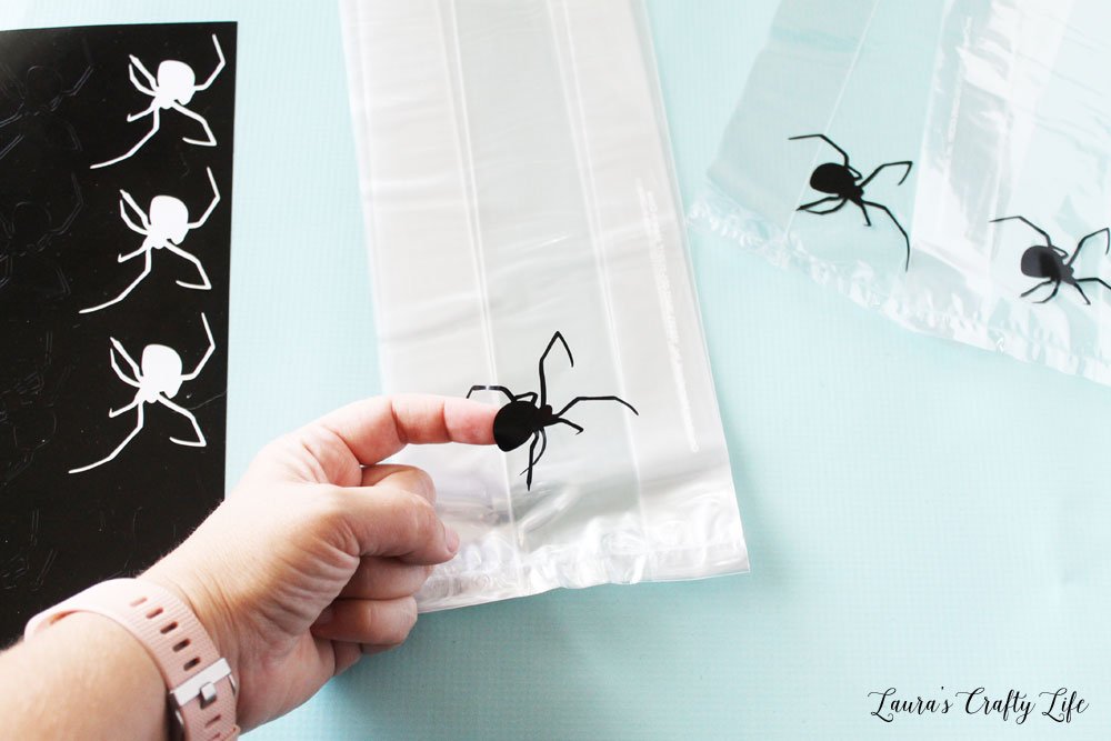 Apply vinyl spiders to clear bags
