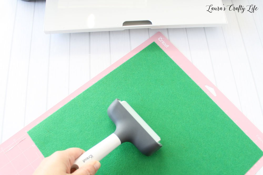 Use brayer to secure felt to mat